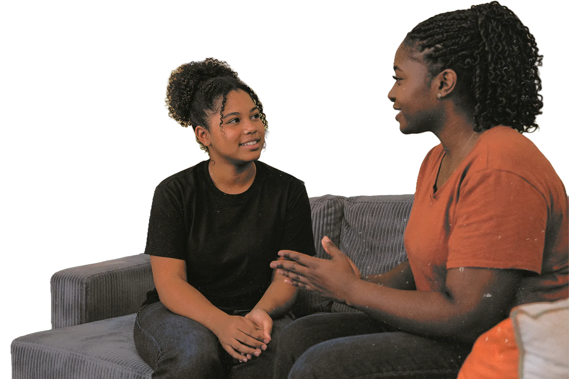 A mentor talking with a young person on a couch